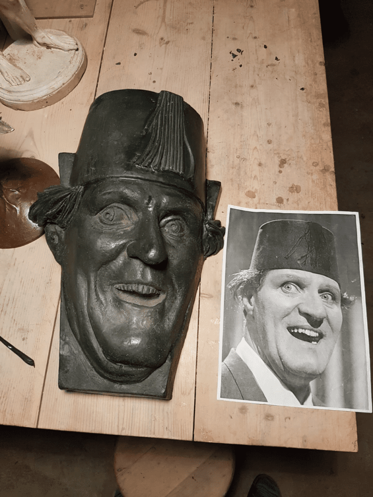 Tommy Cooper Sculpture beside photo Michael C Keane Sculptor